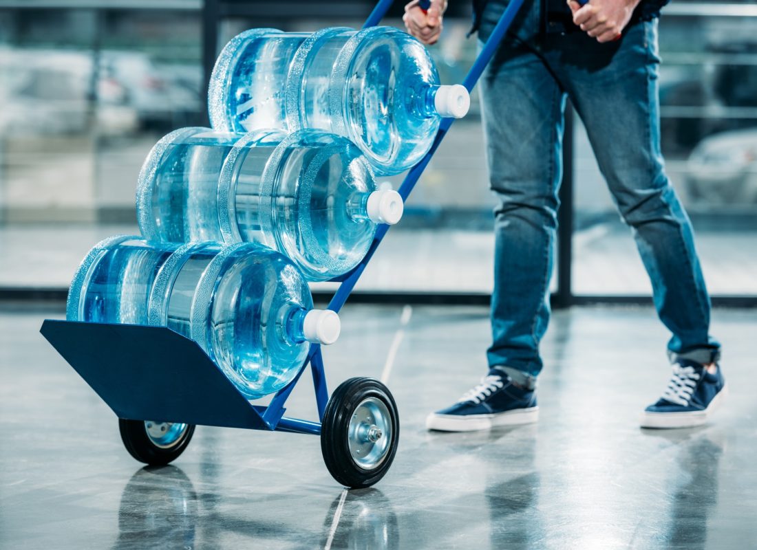 loader-pushing-cart-with-water-bottles.jpg